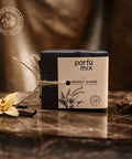 Parfum mix packaging with vanilla flower and vanilla bean on a wooden surface