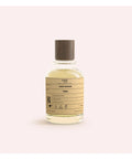 Bottle with a label on a light pink background